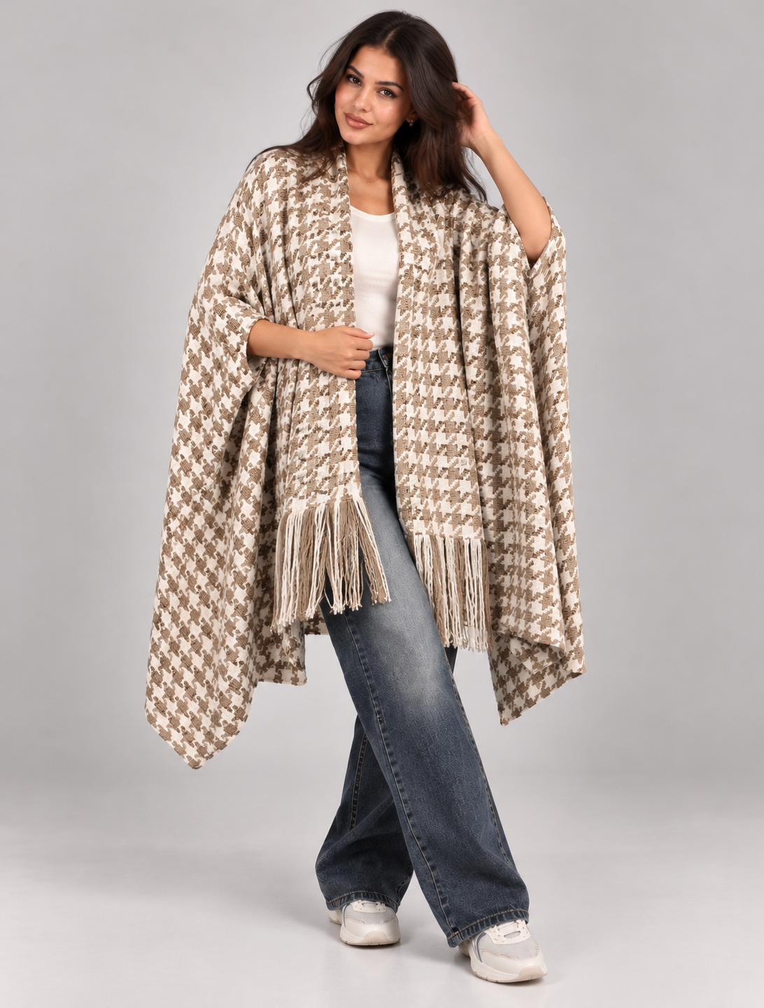 A wide poncho featuring an elegant open front design