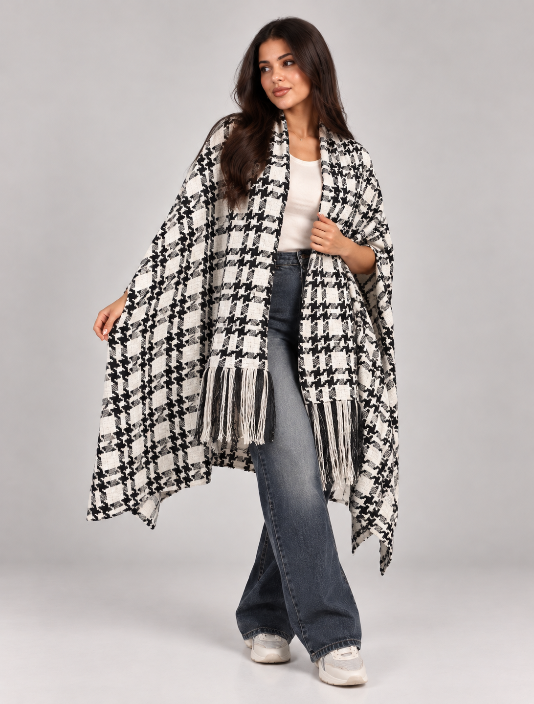A wide poncho featuring an elegant open front design