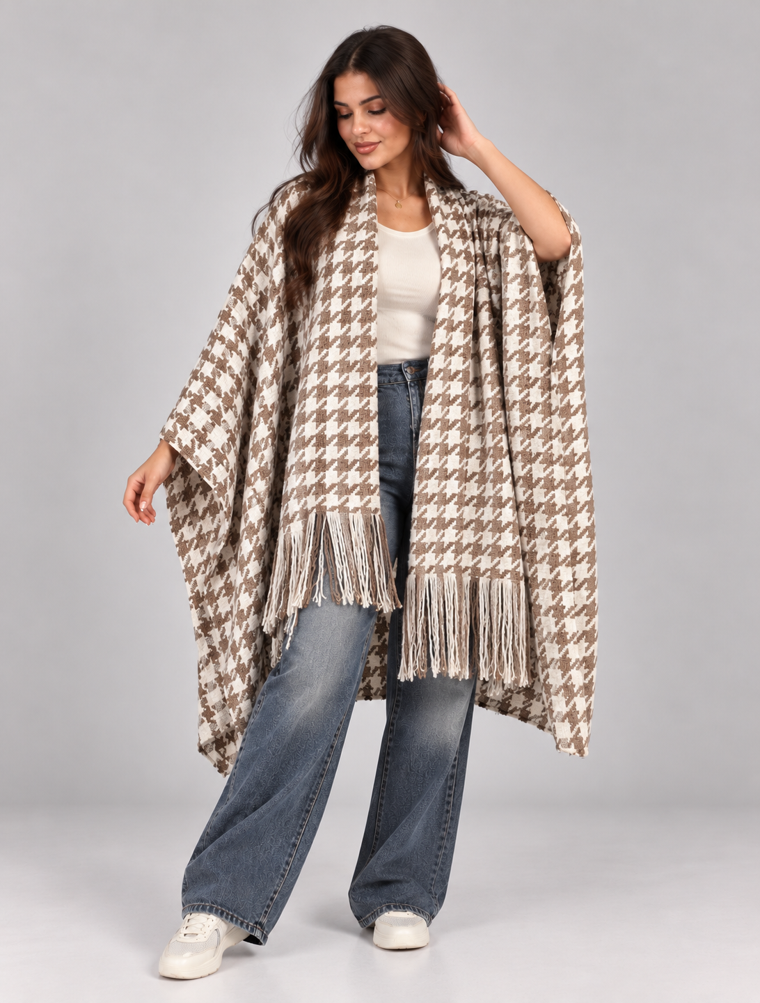 A wide poncho featuring an elegant open front design